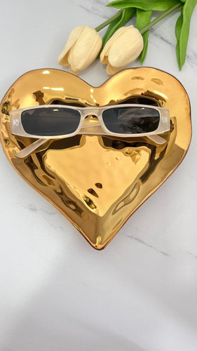 My Girl MT Sunnies placed on a gold heart-shaped dish, showcasing quality jewelry style and aesthetics.
